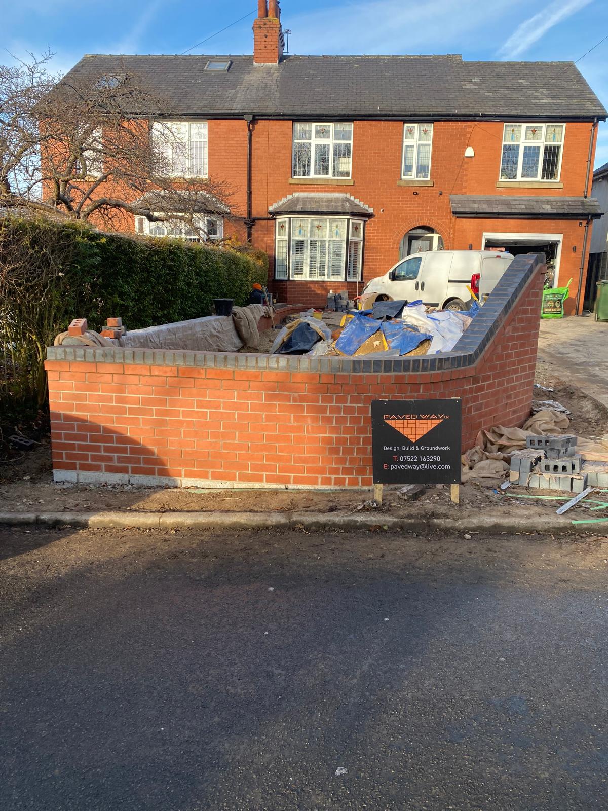 Pavedway LTD site board on a completed brick boundary wall build in Manchester