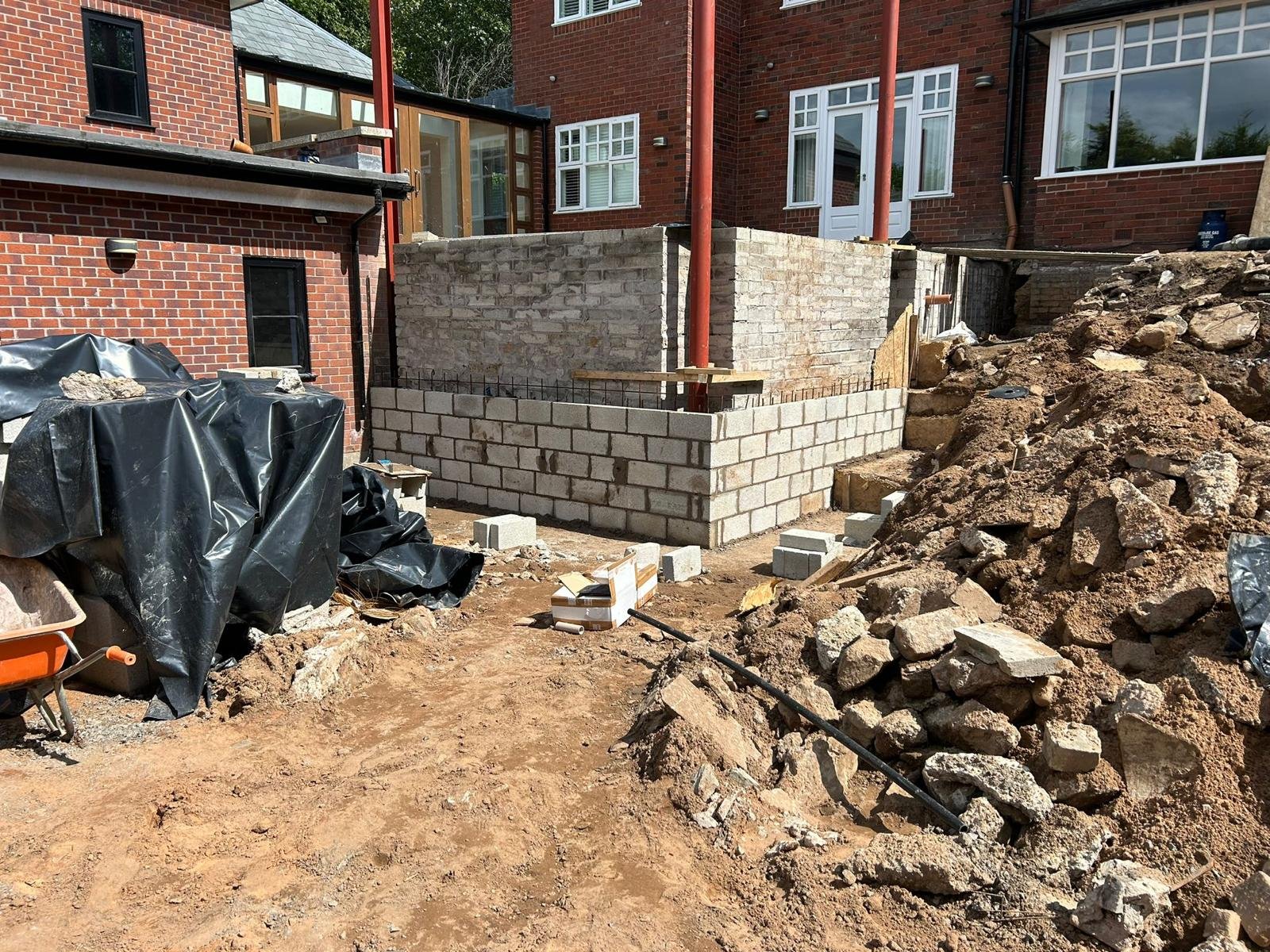Blockwork walls rising with structural steel posts on an extension rebuild