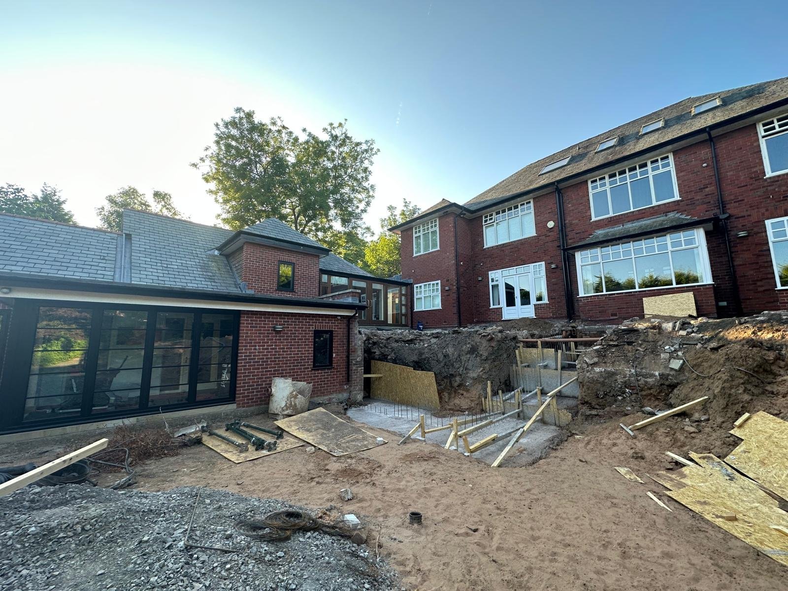 Structural steel posts erected on an extension rebuild before blockwork begins
