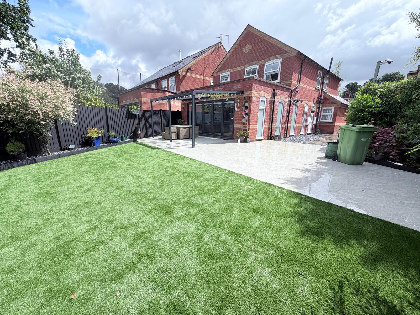 Finished garden with artificial turf, porcelain patio and new fencing