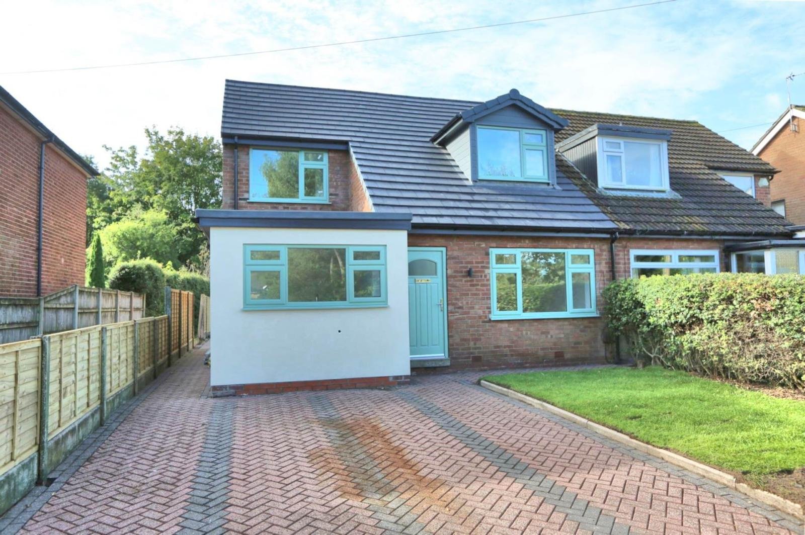Finished home extension and renovation with rendered walls, new windows and herringbone block paving driveway