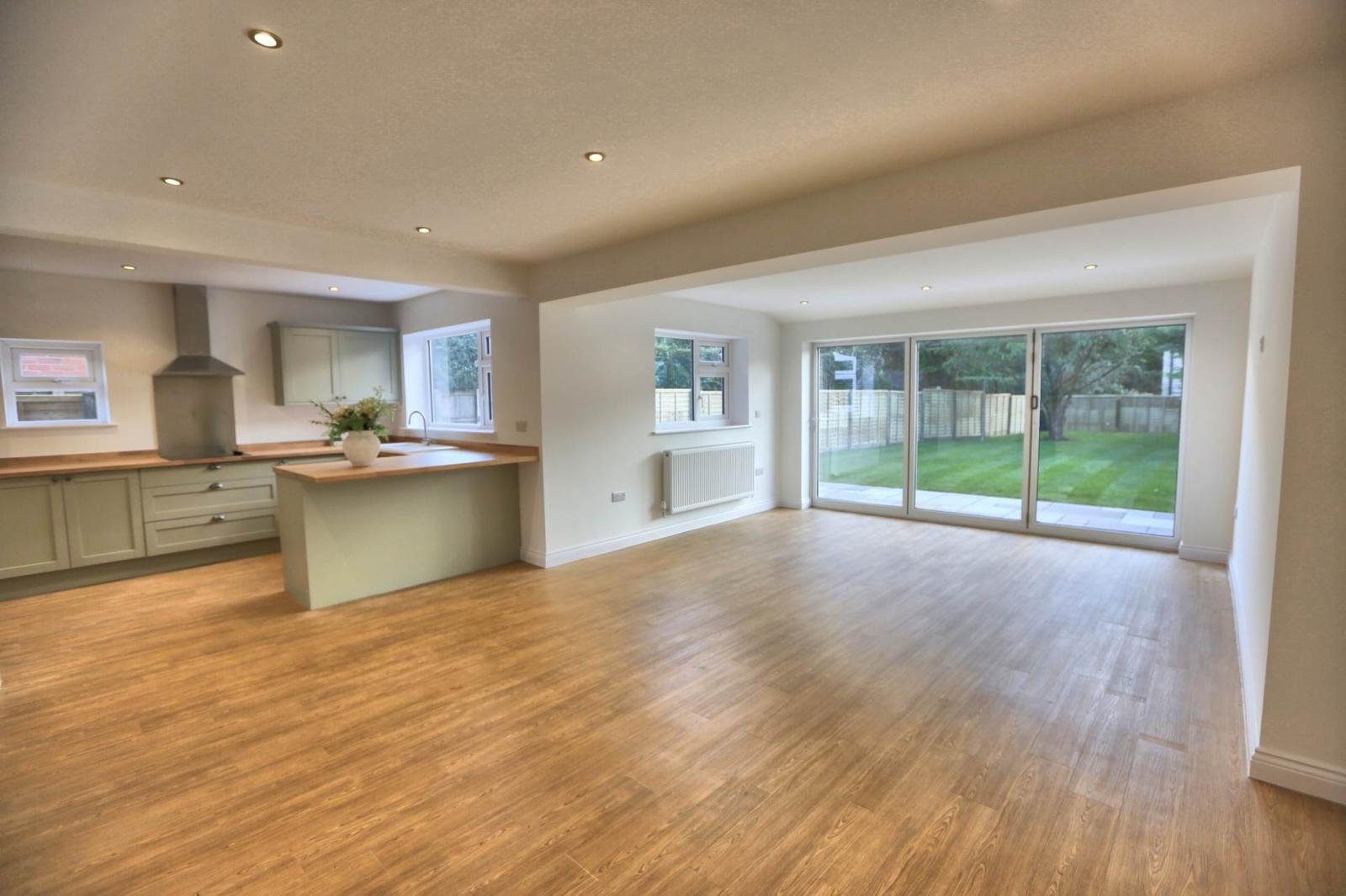 Finished open-plan living space with bi-fold doors onto the garden