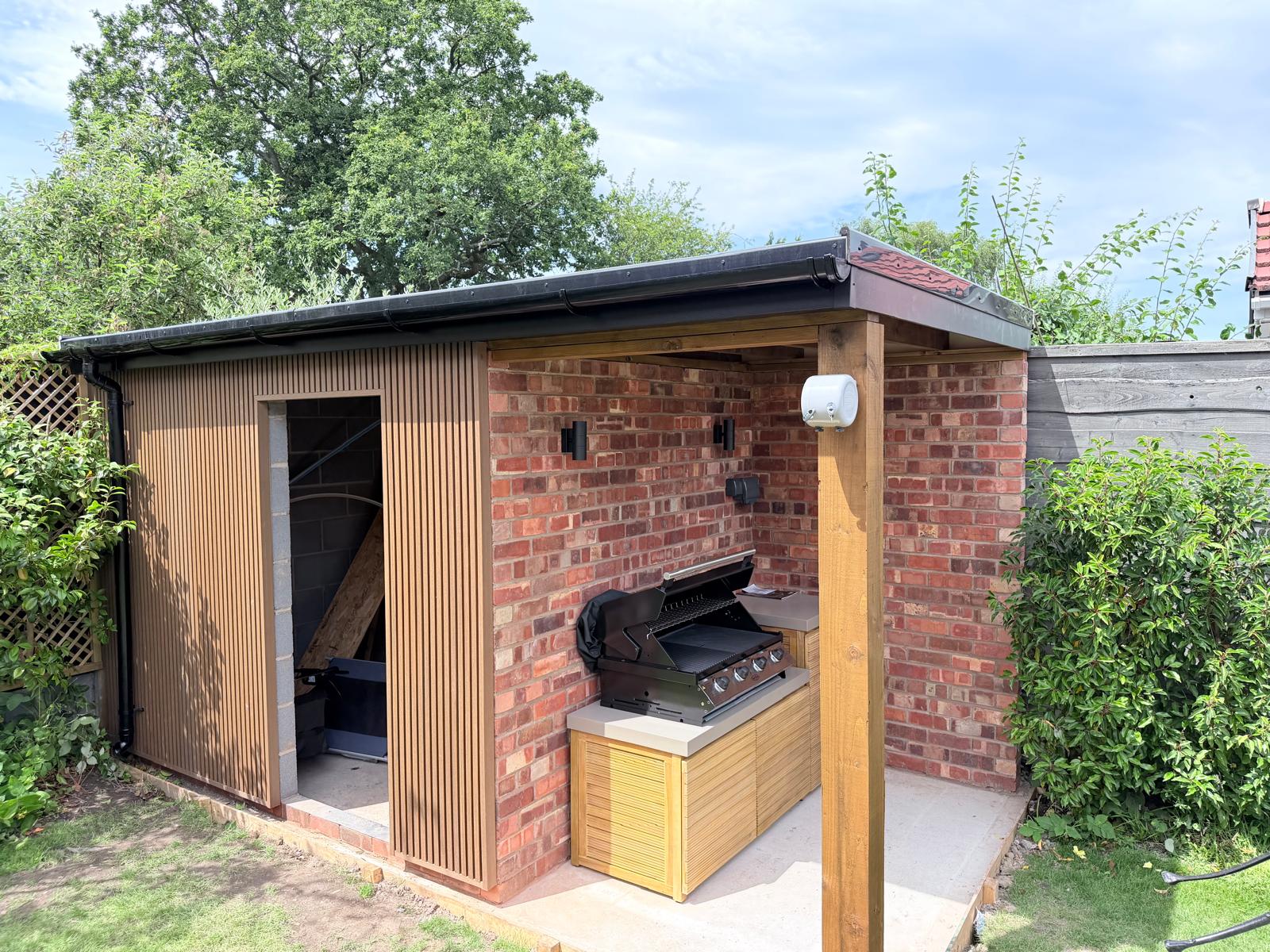 Finished brick garden room with covered outdoor kitchen and BBQ area, built by Pavedway