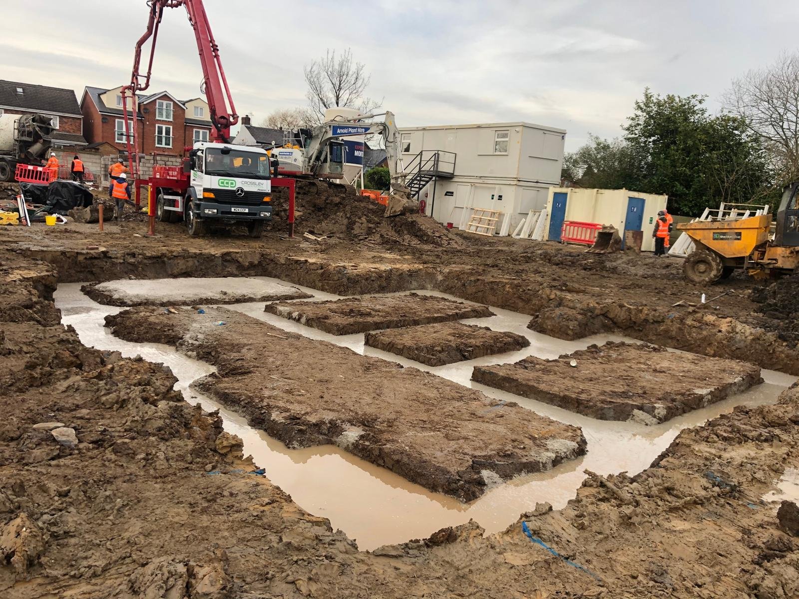 Concrete being poured into foundation trenches on a new build site