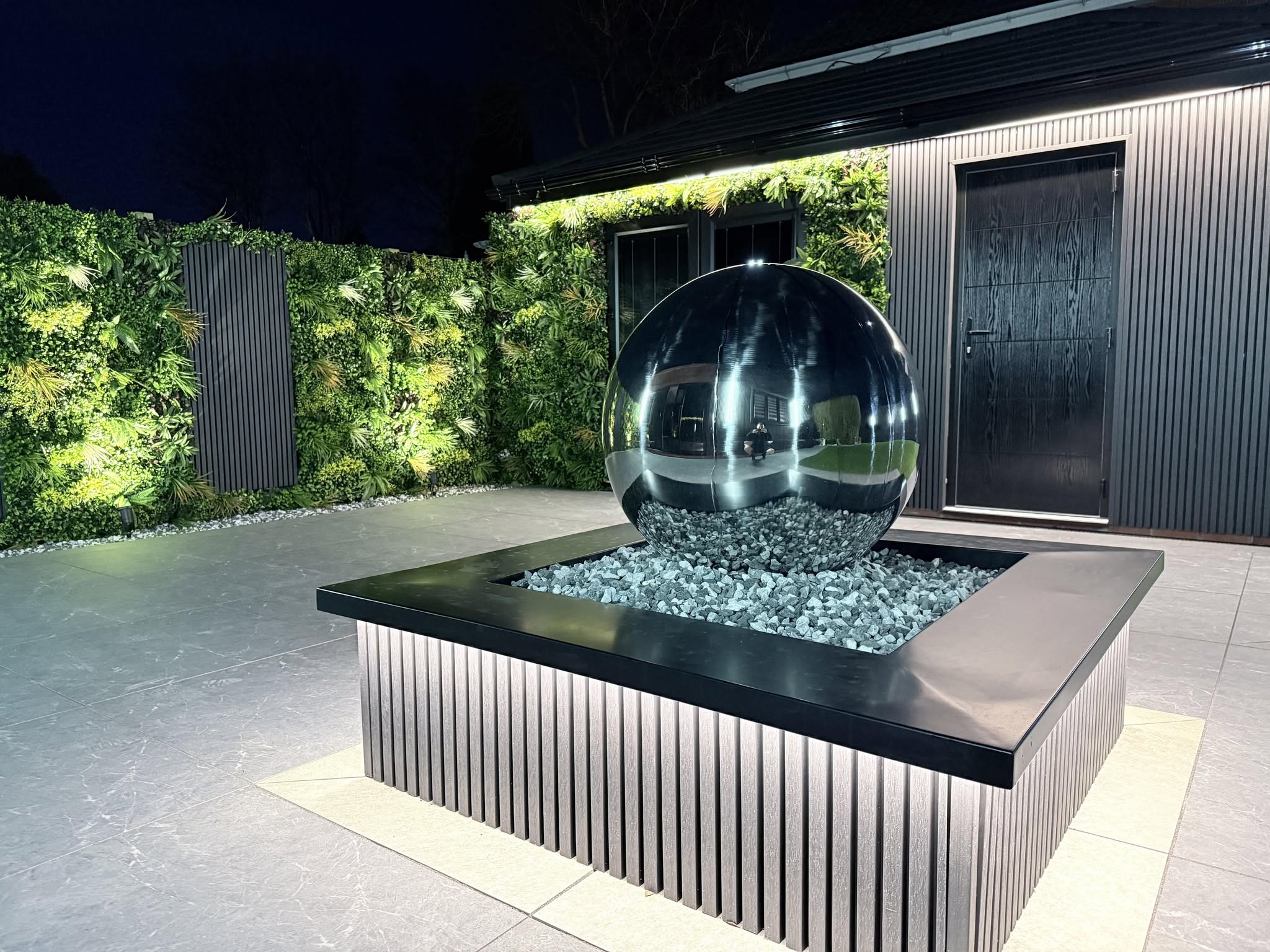 Premium landscaped garden with porcelain paving, artificial lawn and pergola built by Pavedway