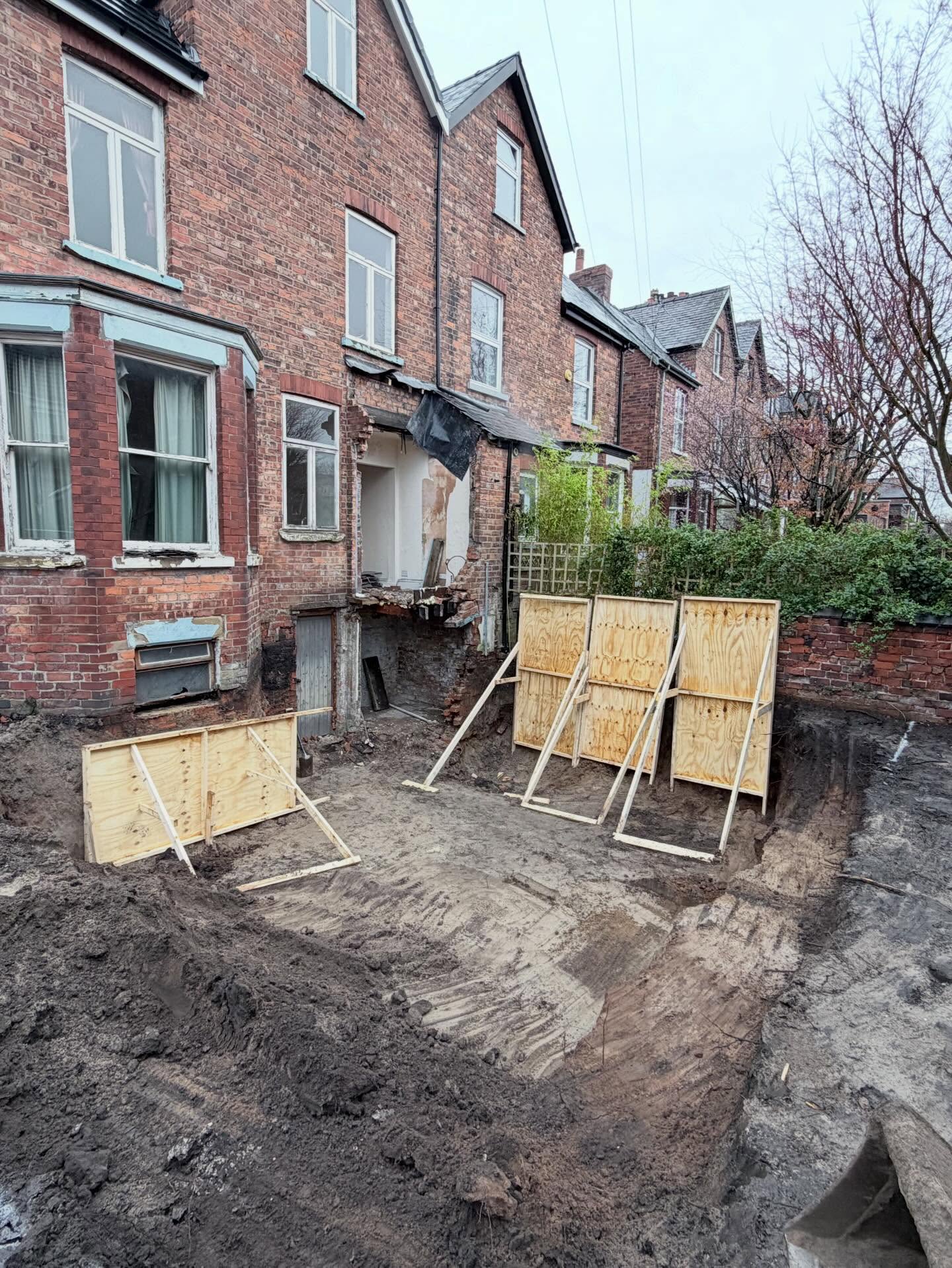Rear extension groundworks with foundation trench and blockwork underway
