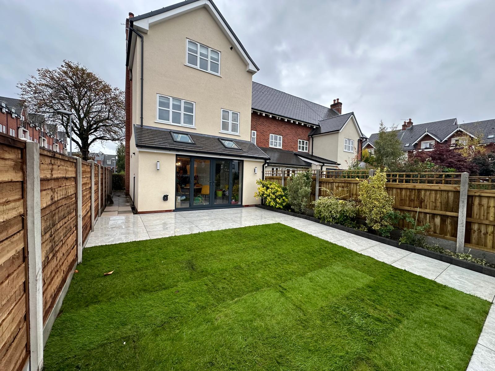 Finished rear garden with porcelain patio and artificial lawn