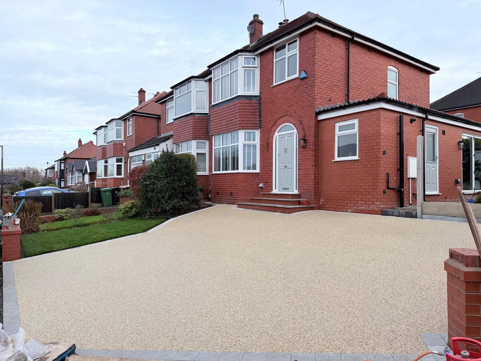 Finished resin-bound driveway with new brick wall and pillars